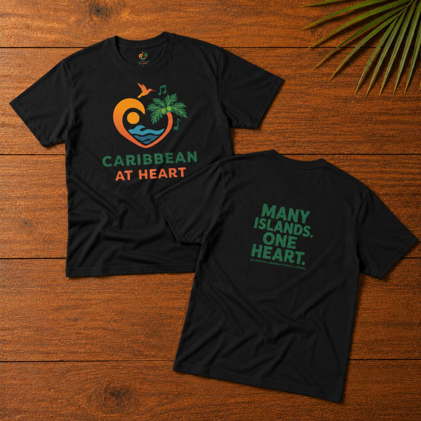 Adult unisex Caribbean graphic t-shirt featuring the Caribbean At Heart logo on the front and Many Islands One Heart artwork on the back.