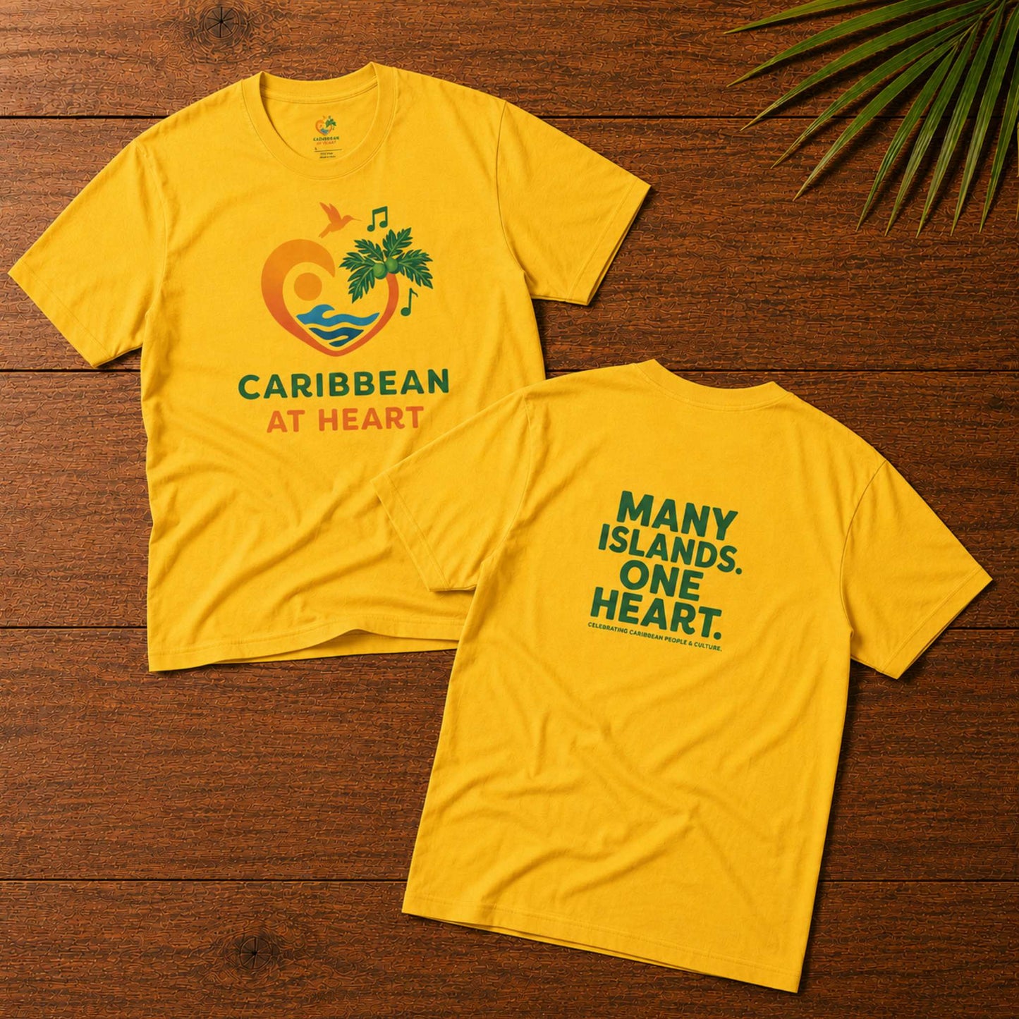Adult unisex Caribbean graphic t-shirt featuring the Caribbean At Heart logo on the front and Many Islands One Heart artwork on the back.