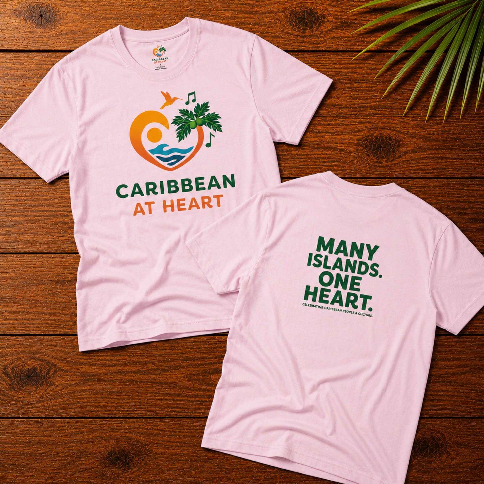 Adult unisex Caribbean graphic t-shirt featuring the Caribbean At Heart logo on the front and Many Islands One Heart artwork on the back.
