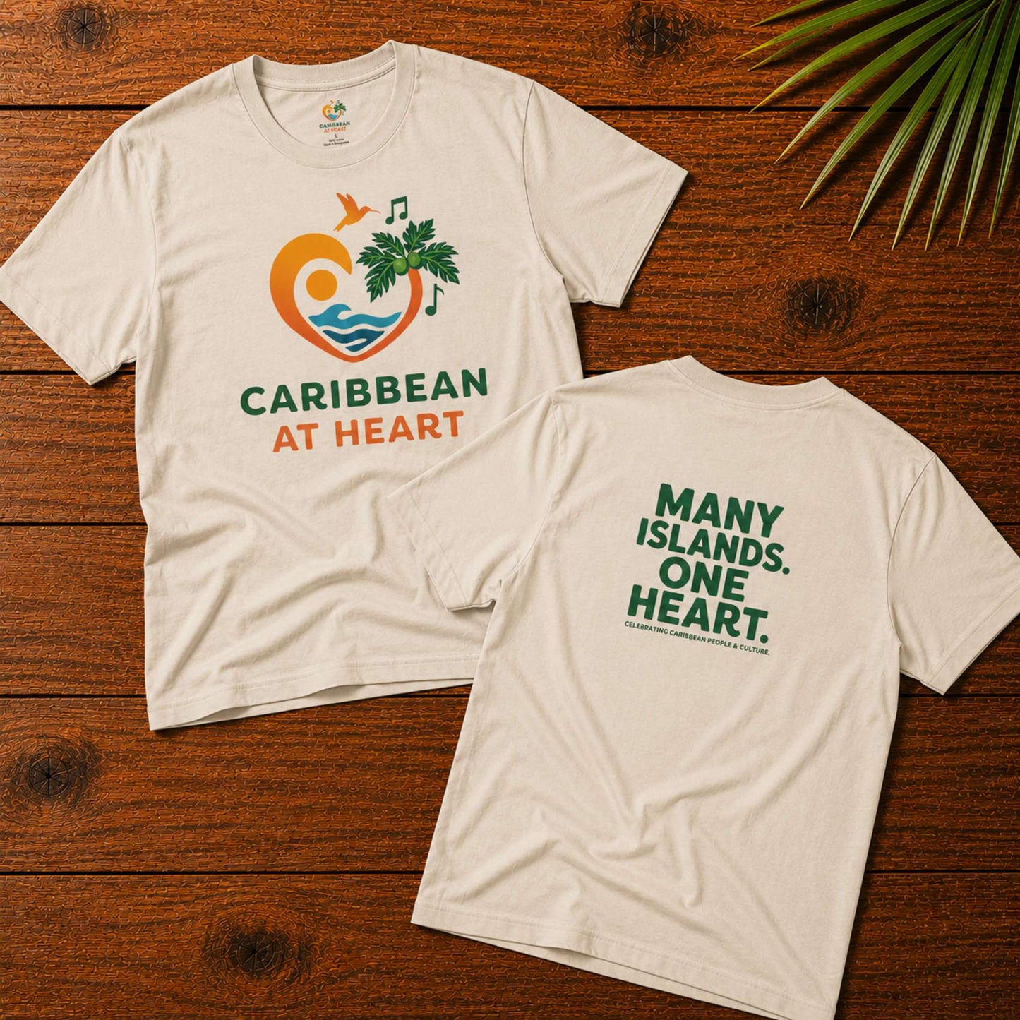 Adult unisex Caribbean graphic t-shirt featuring the Caribbean At Heart logo on the front and Many Islands One Heart artwork on the back.