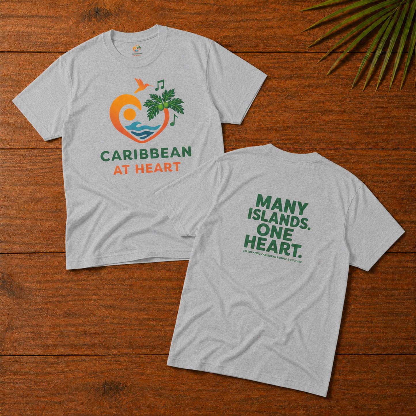 Adult unisex Caribbean graphic t-shirt featuring the Caribbean At Heart logo on the front and Many Islands One Heart artwork on the back.