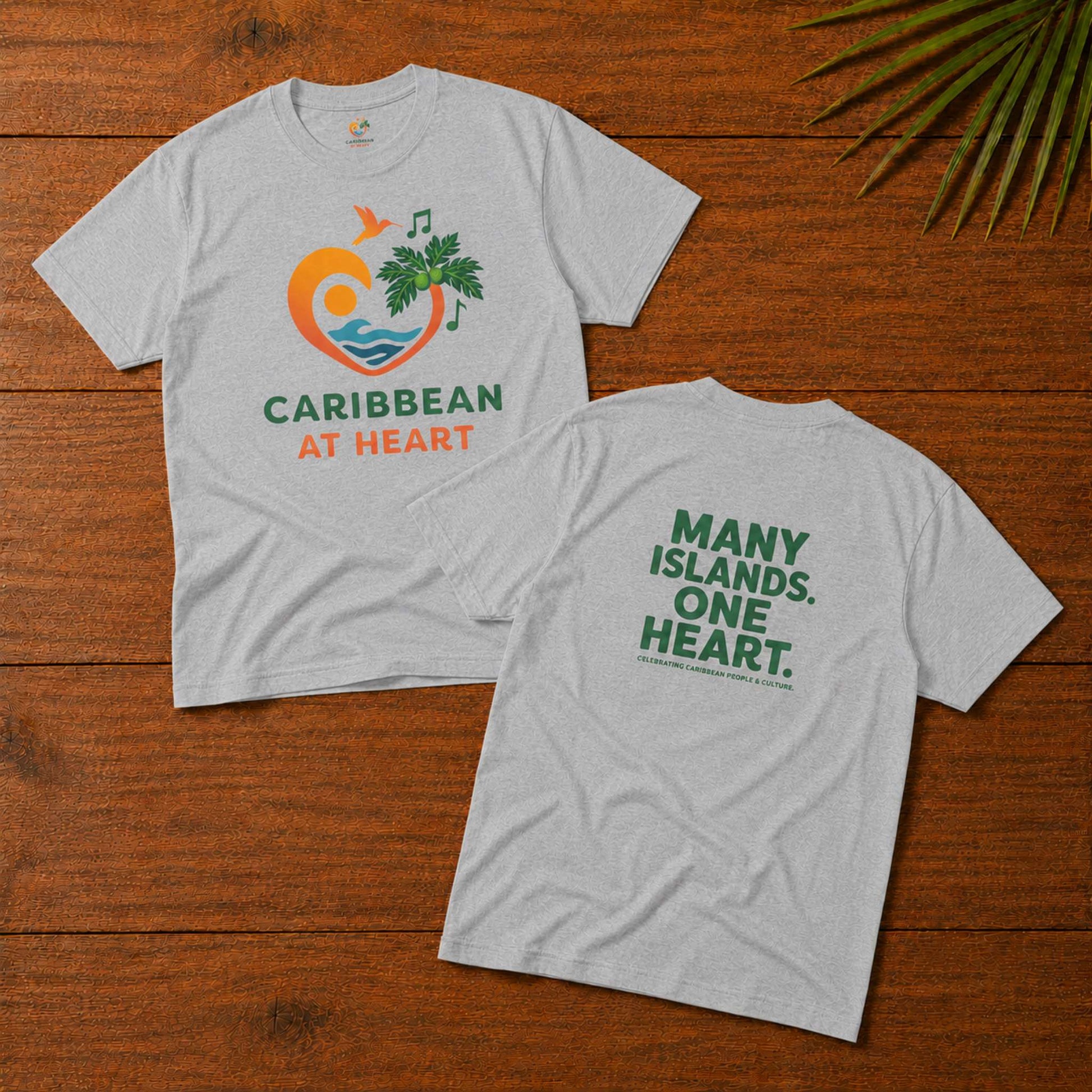 Adult unisex Caribbean graphic t-shirt featuring the Caribbean At Heart logo on the front and Many Islands One Heart artwork on the back.
