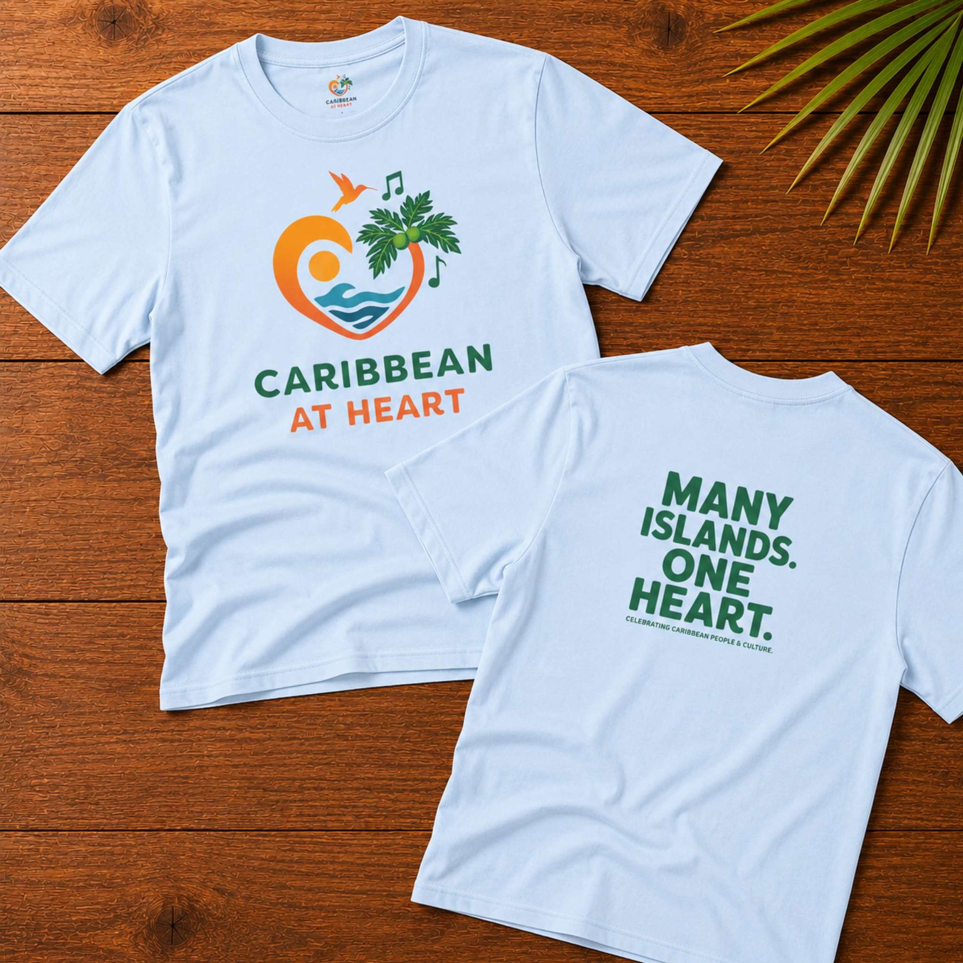 Youth unisex Caribbean graphic t-shirt featuring the Caribbean At Heart logo on the front and Many Islands One Heart artwork on the back.