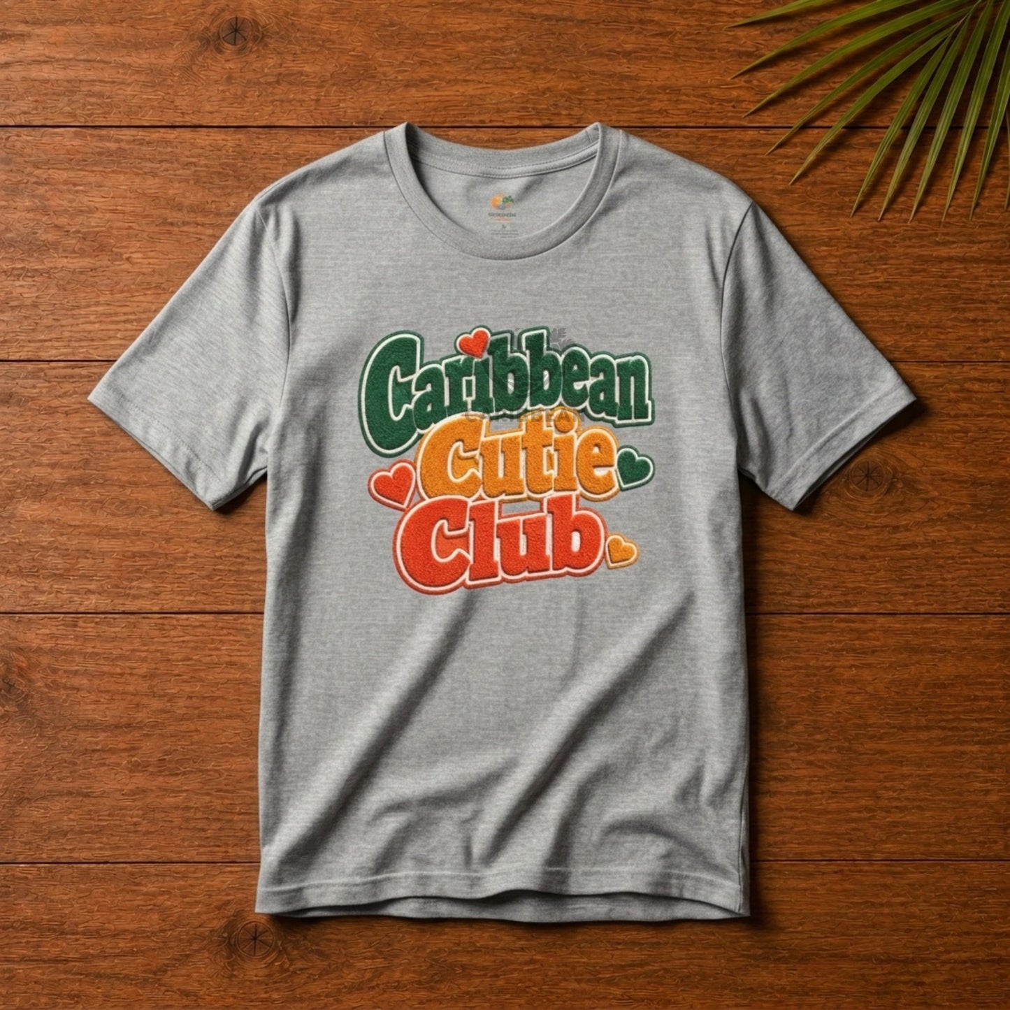 Youth shirt with Caribbean Cutie Club graphic in colorful retro lettering and heart accents.