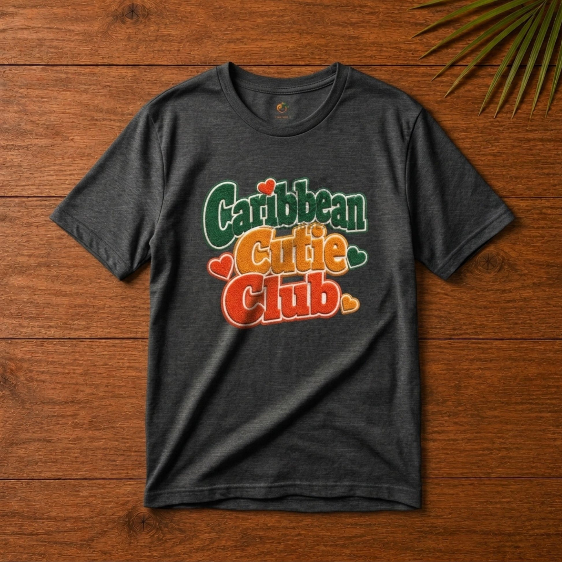 Youth shirt with Caribbean Cutie Club graphic in colorful retro lettering and heart accents.