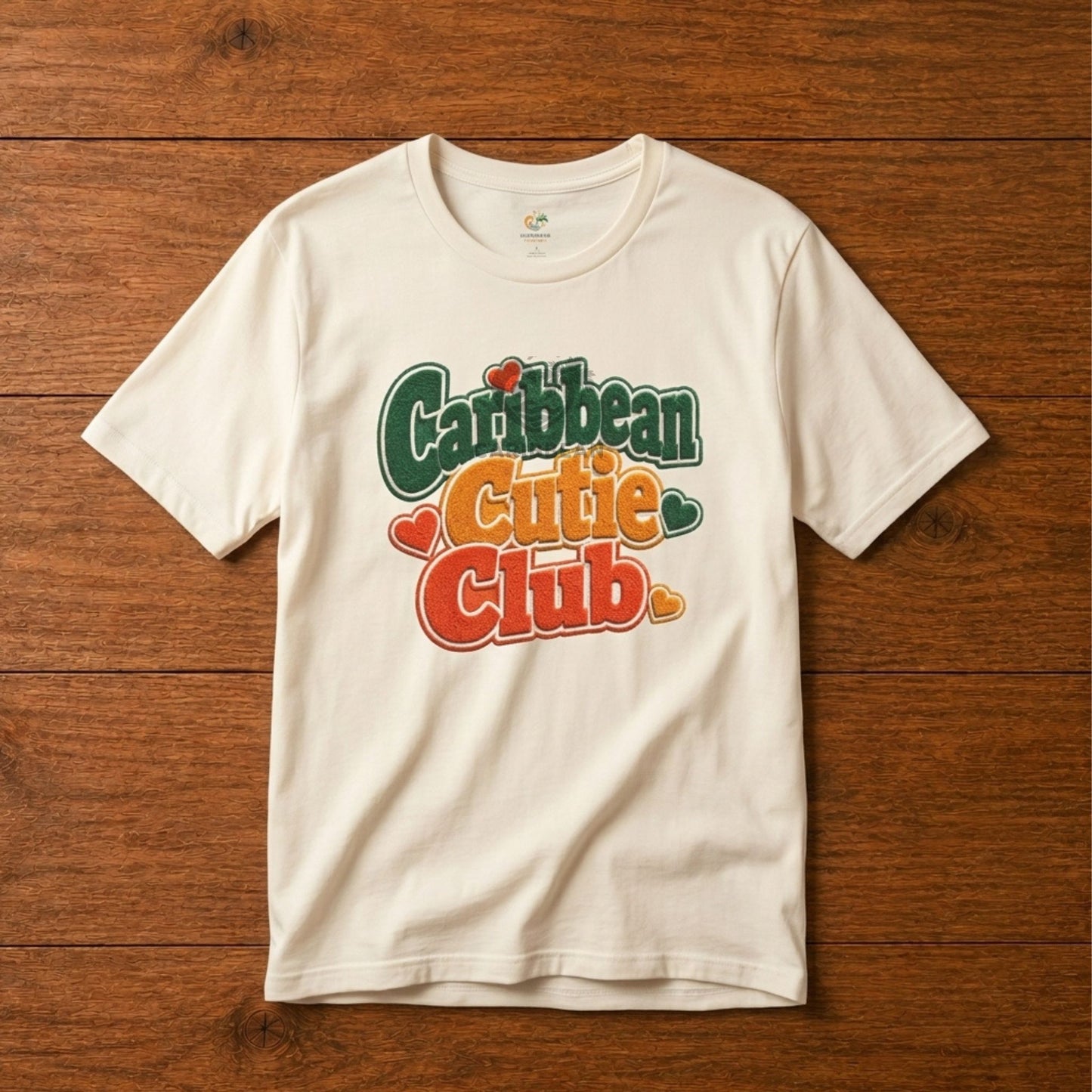 Youth shirt with Caribbean Cutie Club graphic in colorful retro lettering and heart accents.