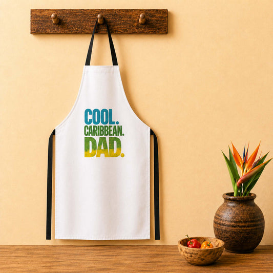 Cool Caribbean Dad apron with bold Caribbean dad graphic in blue, green and yellow lettering.