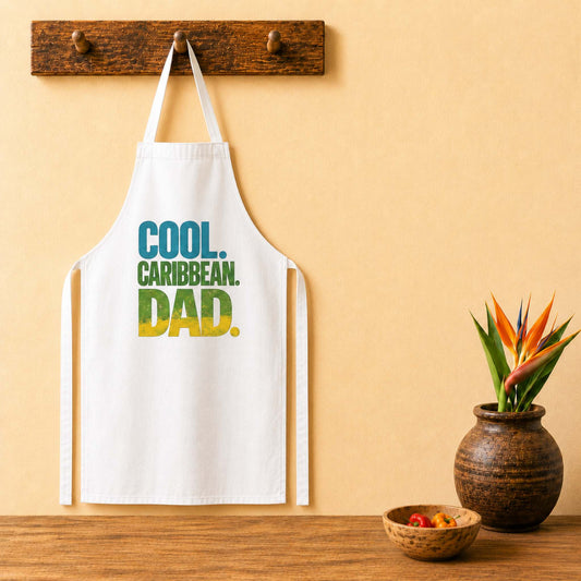 Cool Caribbean Dad apron with bold Caribbean dad graphic in blue, green and yellow lettering.