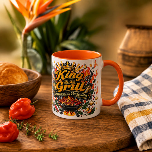 11 oz King uh de Grill Caribbean mug with orange interior and handle, featuring bold barbecue artwork for dads and grill masters.