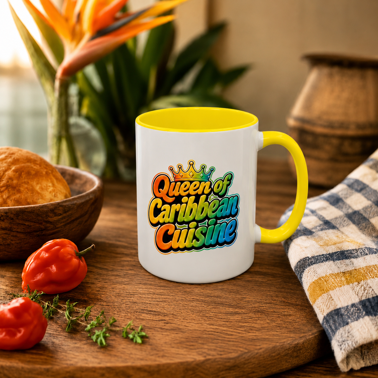 Queen of Caribbean Cuisine accent mug with colorful crown graphic and yellow handle and interior.