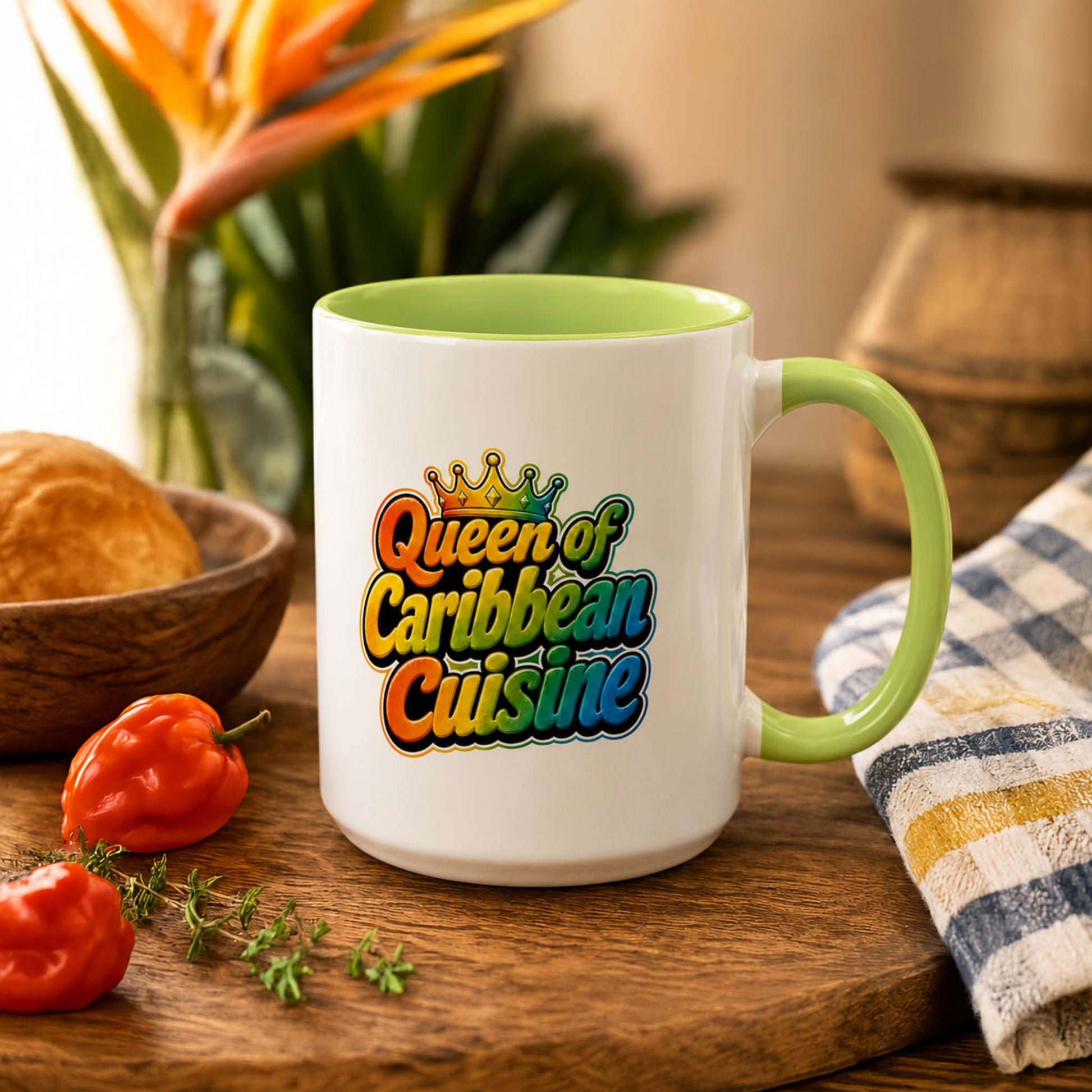 Queen of Caribbean Cuisine accent mug with colorful crown graphic and light green handle and interior.