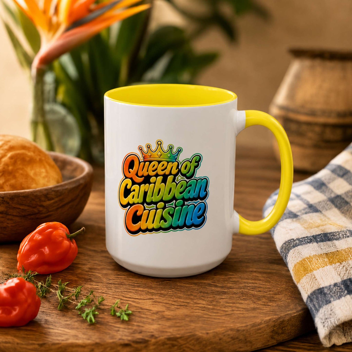Queen of Caribbean Cuisine accent mug with colorful crown graphic and yellow handle and interior.