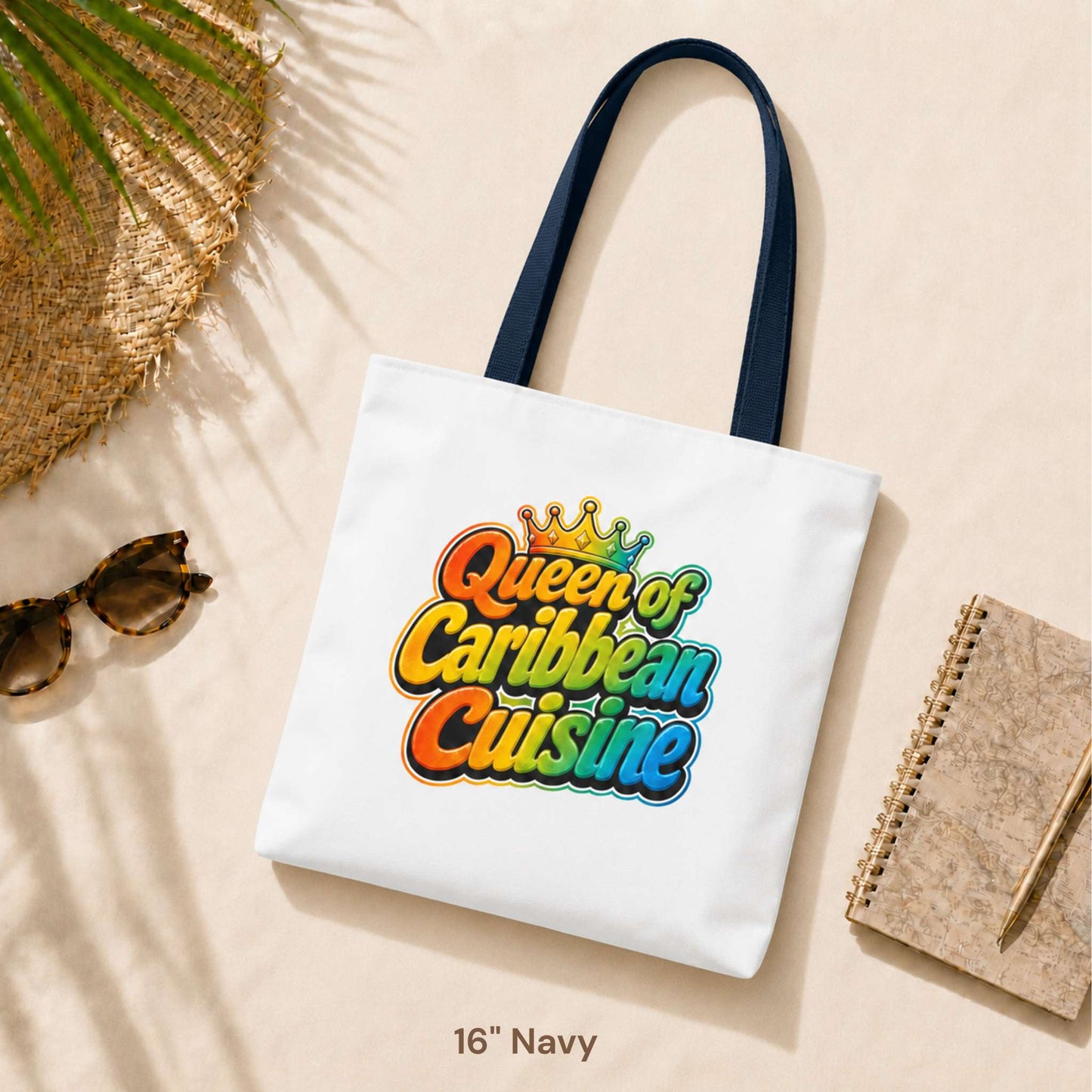 Queen of Caribbean Cuisine tote bag with colorful crown graphic and navy shoulder handles, available in three sizes.