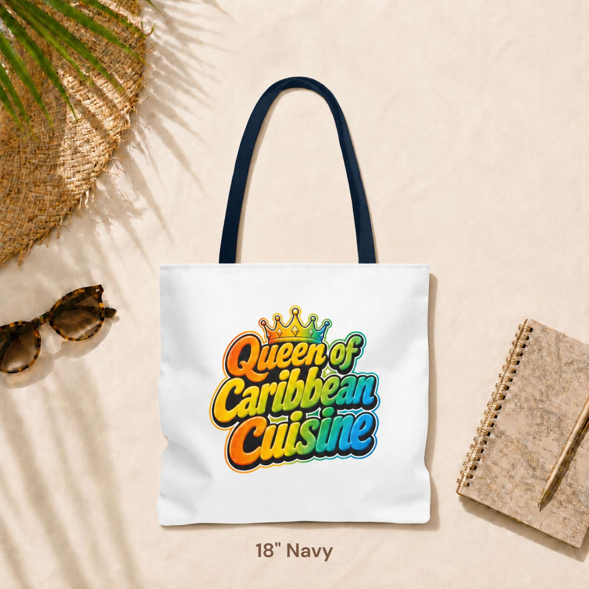 Queen of Caribbean Cuisine tote bag with colorful crown graphic and navy shoulder handles, available in three sizes.