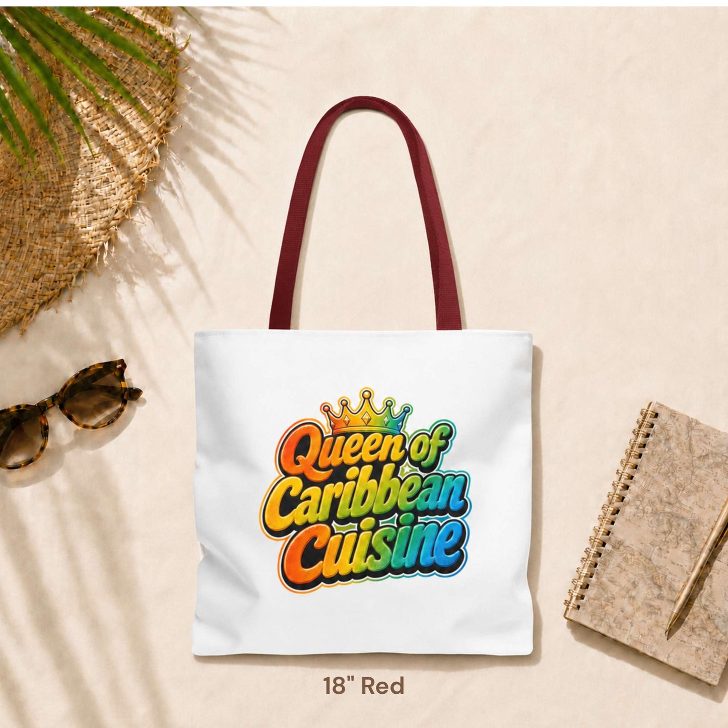 Queen of Caribbean Cuisine tote bag with colorful crown graphic and red shoulder handles, available in three sizes.