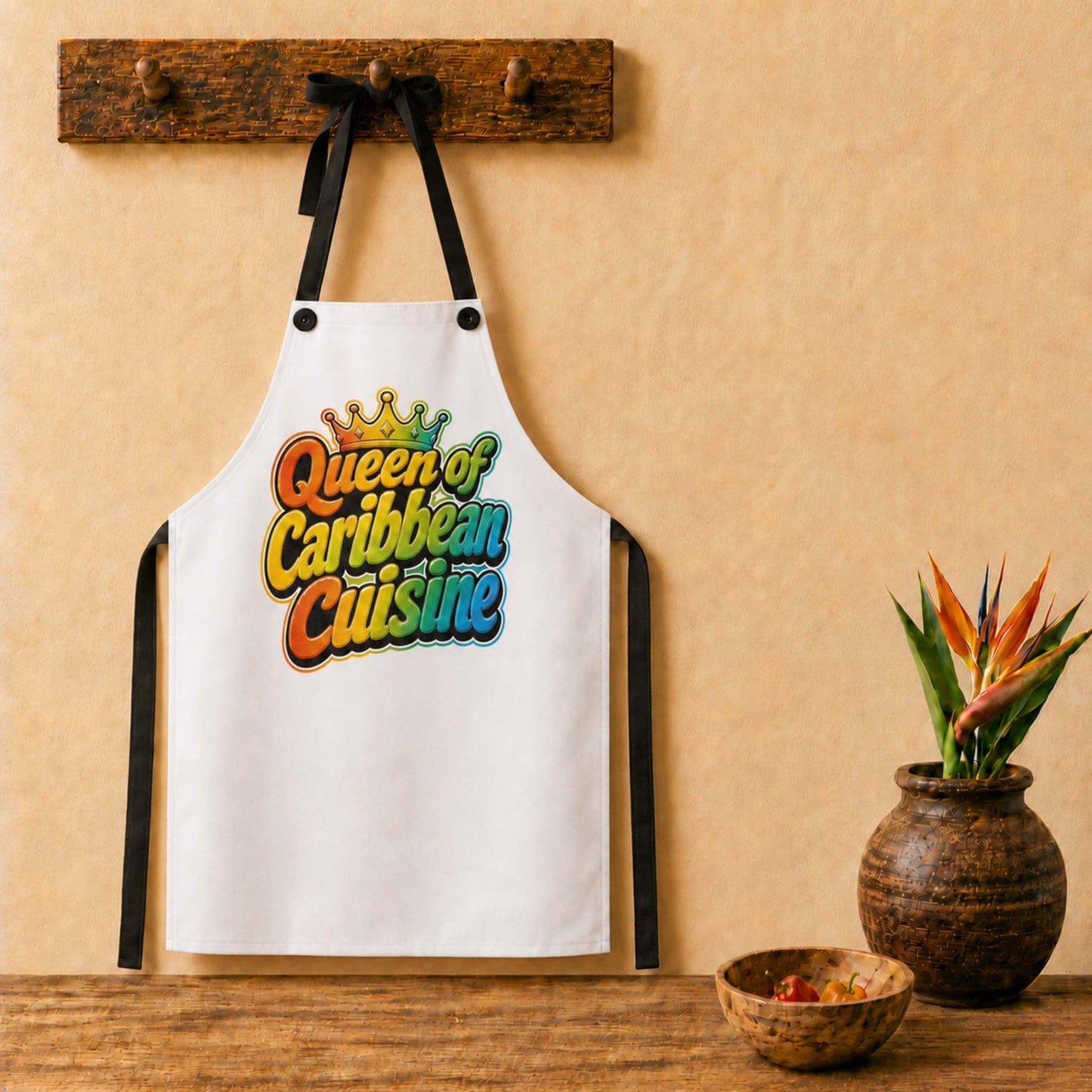 Queen of Caribbean Cuisine apron with colorful crown graphic for Caribbean cooks and food lovers.